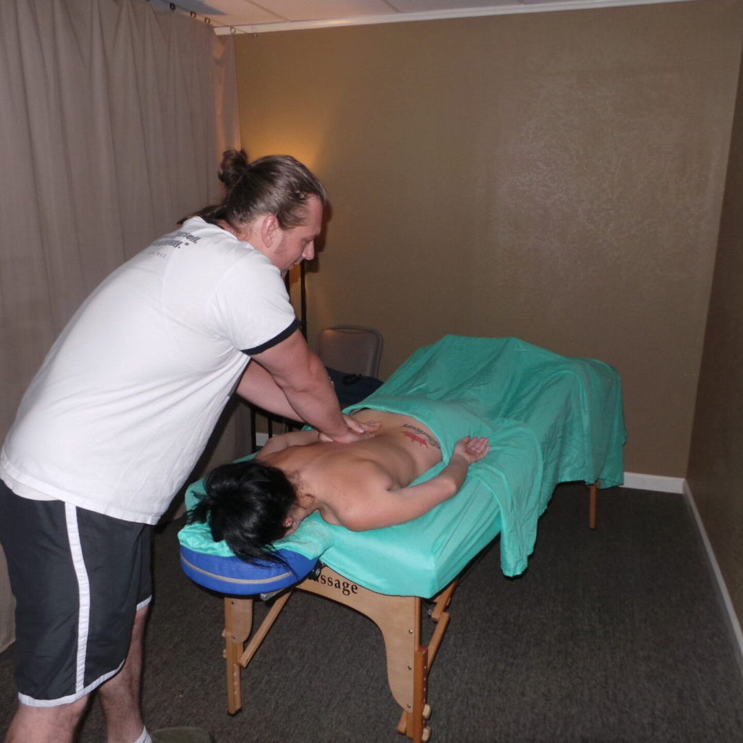 A man is giving a woman a massage.