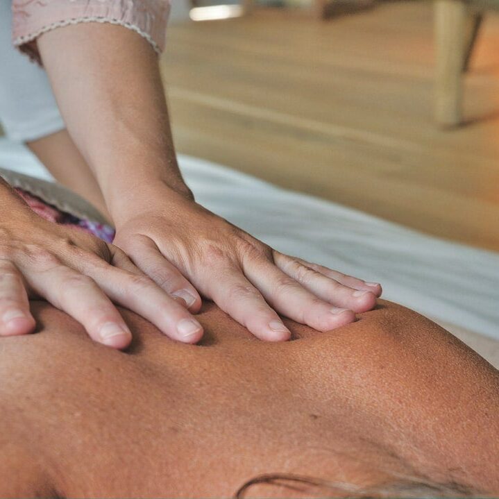 A person is getting their back examined by an acupuncturist.