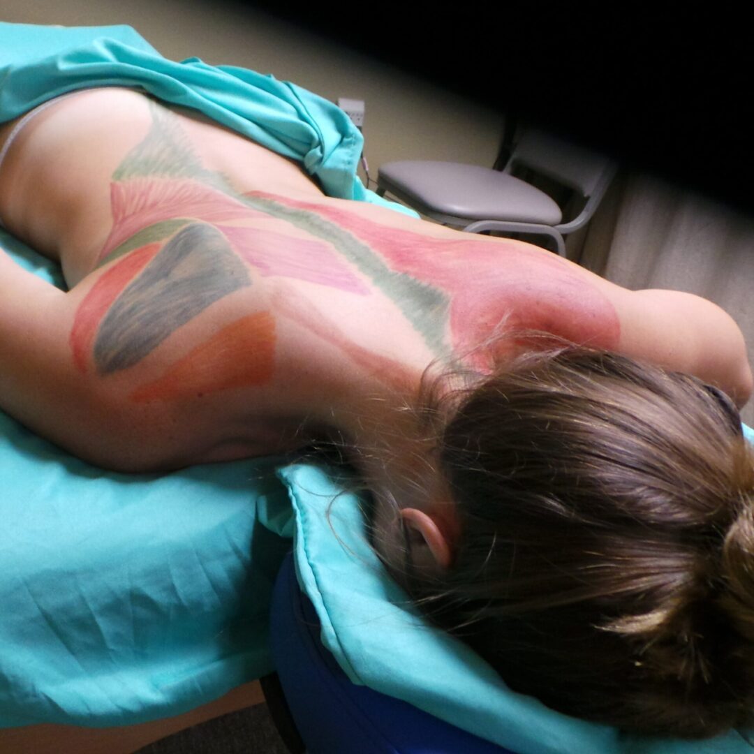 A woman with tattoos on her back and arms.